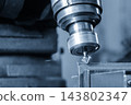 Metal plate deburring process using a chamfer tool on a milling machine in a light blue scene 143802347