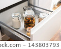 Glass storage jars filled with dry food on modern kitchen countertop 143803793