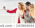 Three women taking selfie outdoor 143804044