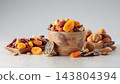 Assorted nuts and dried fruits in wooden dish. 143804394