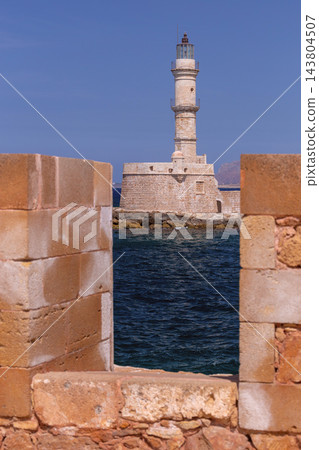 Historic Venetian Lighthouse Behind Stone Wall in Chania, Crete, Greece Historic Venetian Lighthouse Behind Stone Wall in Chania, Crete, Greece 143804507