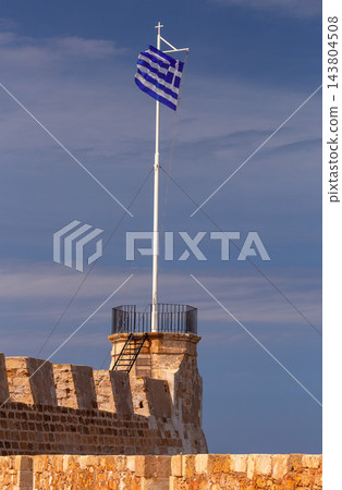 Greek Flag and Historic Stone Arch at Venetian Harbor in Chania, Crete Greek Flag and Historic Stone Arch at Venetian Harbor in Chania, Crete 143804508