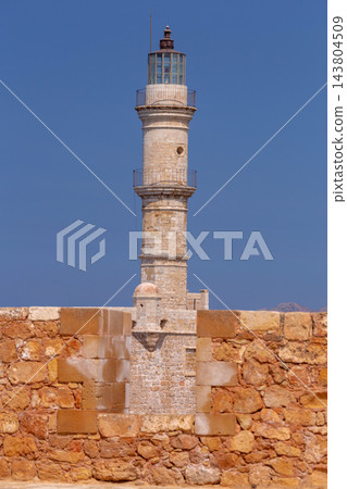 Historic Venetian Lighthouse Behind Stone Wall in Chania, Crete, Greece Historic Venetian Lighthouse Behind Stone Wall in Chania, Crete, Greece 143804509