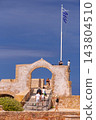 Greek Flag and Historic Stone Arch at Venetian Harbor in Chania, Crete 143804510