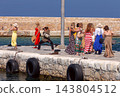Tourists Taking Photos at the Venetian Harbor in Chania, Crete, Greece 143804512