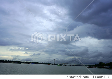Vidyasagar Setu cable stayed bridge over Hooghly river under dark monsoon clouds in Kolkata Vidyasagar Setu cable stayed bridge over Hooghly river under dark monsoon clouds in Kolkata 143805107