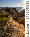 Scenic sunset view of sandstone cliffs and canyon leading to Arenosillo beach in Mazagon, Huelva, Spain. Great for travel guides, Andalusian tourism, and nature blogs. 143805336