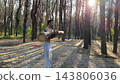 Hardy shirtless sportsman lifting wooden log at summer forest. Young athletic guy exercises with hard weight training biceps. Strong muscular man working at sunny woodland. Active lifestyle concept 143806036