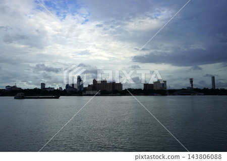 Kolkata city skyline along the wide Hooghly river under a cloudy dramatic sky Kolkata city skyline along the wide Hooghly river under a cloudy dramatic sky 143806088