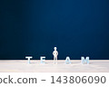 Teamwork, collaboration and belonging concept with businessman among TEAM letters 143806090