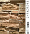 Texture of a beige stone wall made of decorative brick 143806956