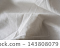 Soft light and a wrinkled white fabric background texture 143808079