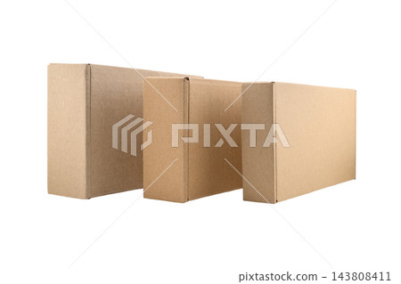 three cardboard boxes standing side by side on their edges on a white isolated background 143808411
