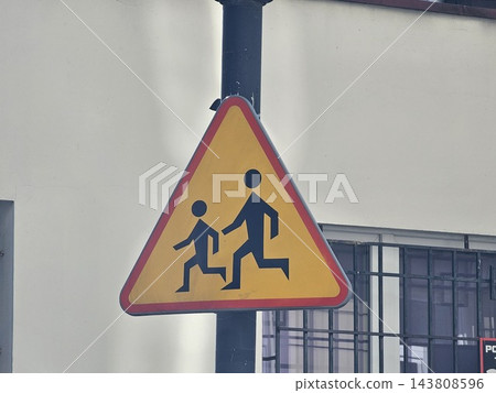 Yellow Children Crossing Warning Sign on Warsaw Street Yellow Children Crossing Warning Sign on Warsaw Street 143808596
