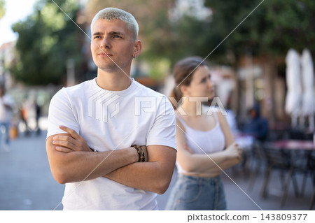 guy is offended by his girlfriend and is standing on the street 143809377