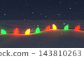 Red, green, and gold Christmas lights shining on the snow - a winter night backdrop 143810263