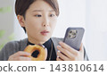 Middle-aged woman binge eats sweets due to stress 143810614