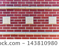 Red Brick Wall with Decorative Stone Blocks and Horizontal Trim 143810980