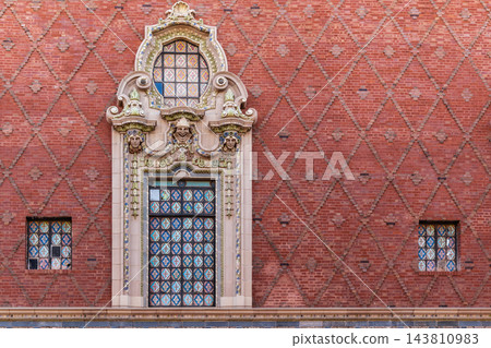 Ornate Window Surround and Diamond Brickwork on a Red Brick Facade 143810983