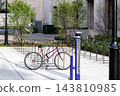 Purple Bicycle Beside a Public Repair Station and Bike Racks 143810985