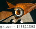 Top view of an espresso shot with rich crema on a wooden table with strong sunlight and a person standing 143811398