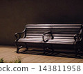 A deserted bench at night 143811958