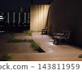 A deserted bench at night 143811959