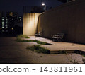 A deserted bench at night 143811961