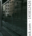 The scenery reflected in the glass of the building 143812426