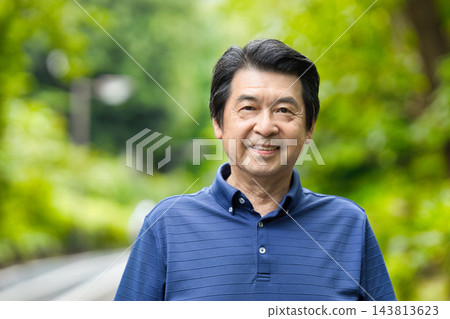 A senior man smiling amidst the greenery A senior man smiling amidst the greenery 143813623