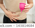 Asian woman holding menstrual cup for hygiene menstrual period cycle protection. 143814684