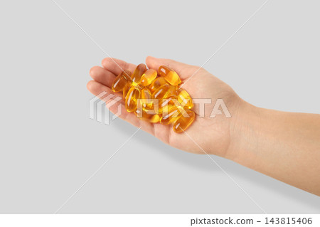 Omega 3. Person offers omega fish oil capsules in hand. Healthy lifestyle and nutrition concept. Omega 3. Person offers omega fish oil capsules in hand. Healthy lifestyle and nutrition concept. 143815406