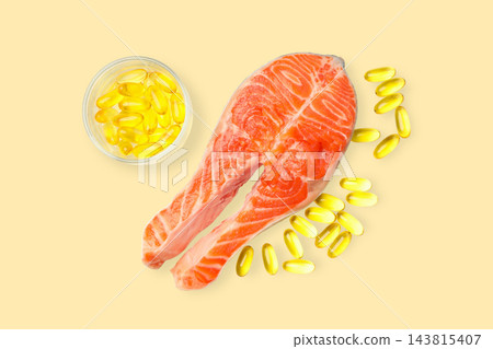 Omega 3. Salmon fillet placed next to fish oil capsules on light background. 143815407