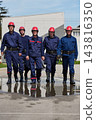 Firefighters Team Walking Together In Uniforms With Red Helmets Showing Teamwork And Readiness 143816350