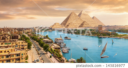 Epic Aswan cityscape panorama at sunset with Nile river and urban skyline on Egypt pyramids travel route 143816977