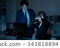 Male and female businessmen working overtime in the office 143818894