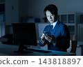 A businessman who works overtime in the office 143818897