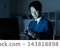 A businessman who works overtime in the office 143818898