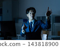 A businessman who works overtime in the office 143818900