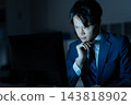 A businessman who works overtime in the office 143818902
