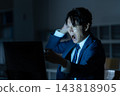 A businessman who works overtime in the office 143818905