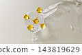 Clear serum drop with gold oil molecule and collagen peptide jelly gel texture on white 3d background. Transparent liquid cosmetic wavy surface with bubbles, beauty skincare product. 3D illustration 143819629