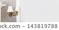 Vintage brass wall sconce on damask wallpaper 143819788