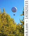 Ginkgo trees and balloons floating in the blue sky 143820235