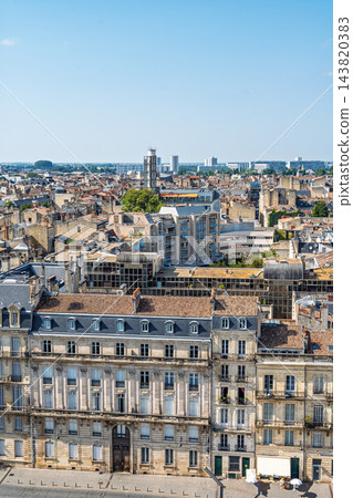 Aerial view of the historic city center of Bordeaux in France showing traditional stone architecture and rooftops under a clear bright summer sky Aerial view of the historic city center of Bordeaux in France showing traditional stone architecture and rooftops under a clear bright summer sky 143820383