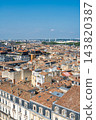 Aerial view of historic Bordeaux city rooftops in France featuring traditional terracotta tiles and classic architecture under a bright summer sky 143820387