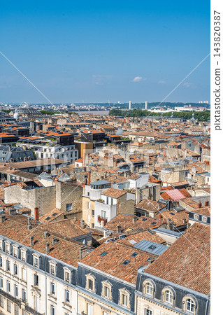 Aerial view of historic Bordeaux city rooftops in France featuring traditional terracotta tiles and classic architecture under a bright summer sky Aerial view of historic Bordeaux city rooftops in France featuring traditional terracotta tiles and classic architecture under a bright summer sky 143820387