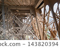 Detailed view of the intricate iron metal framework of the Eiffel Tower in Paris France showing structural steel beams and rivets in daylight 143820394