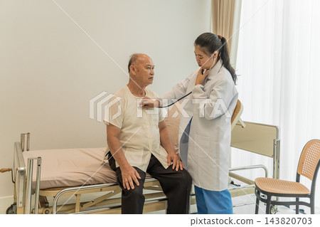 Female doctor explaining treatment options to elderly man in clinic. Female doctor explaining treatment options to elderly man in clinic. 143820703
