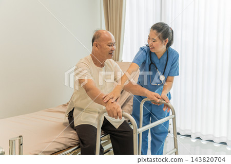 Senior man receiving assistance from nurse in modern healthcare setting. 143820704